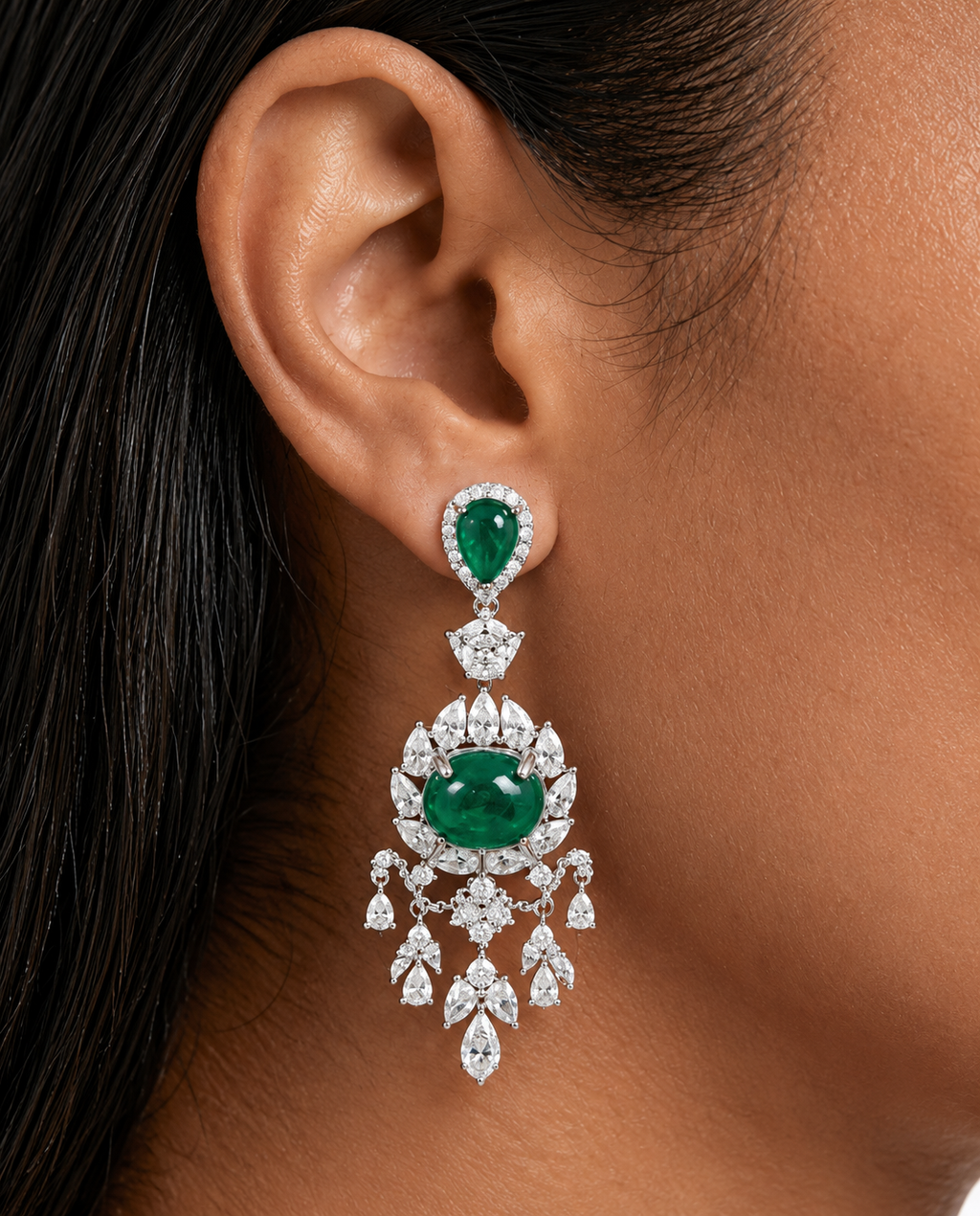 Close-up of Vionne emerald-green chandelier earring worn on the ear
